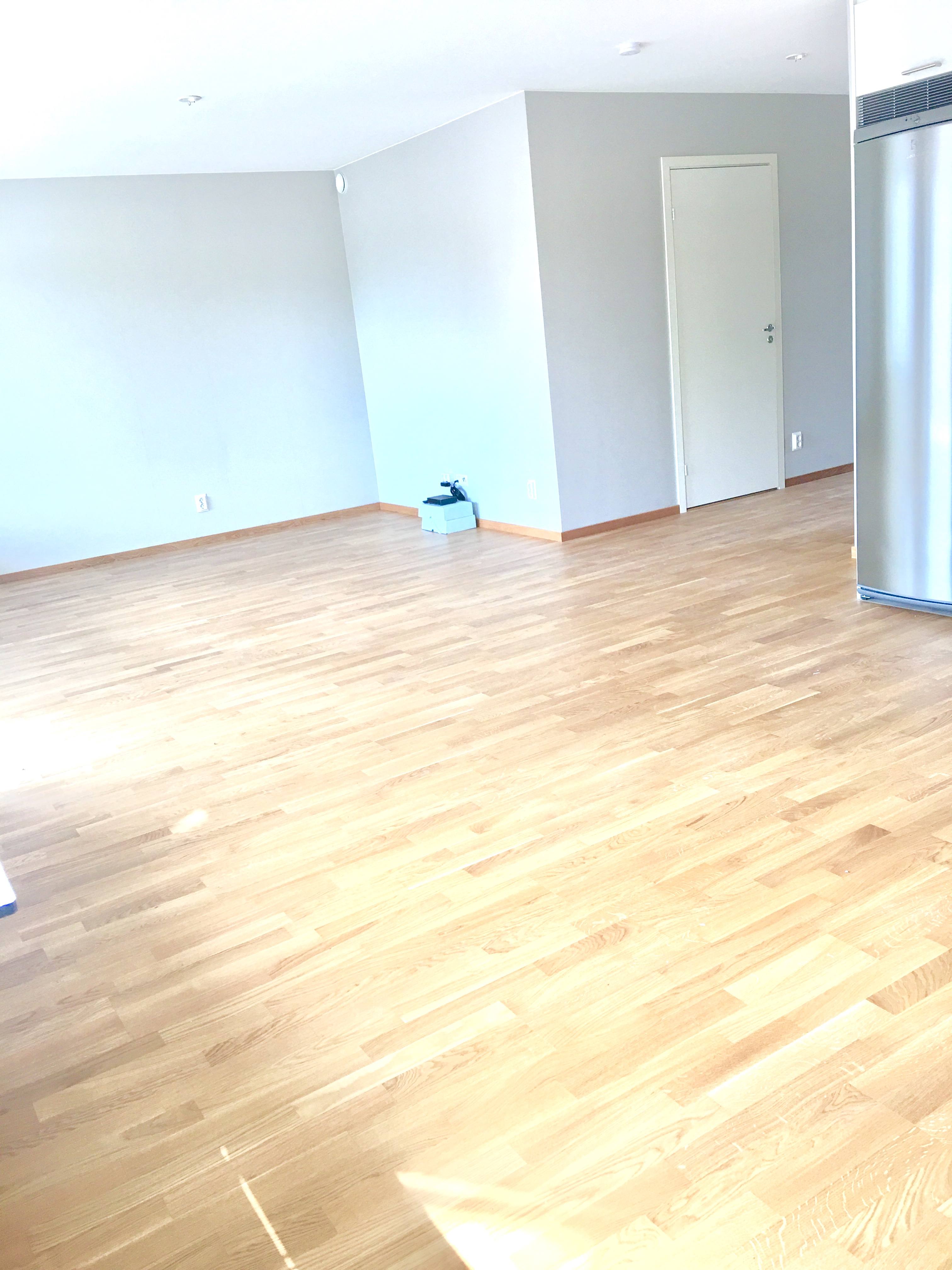 Från kök mot vardagsrum som är i öppen planlösning